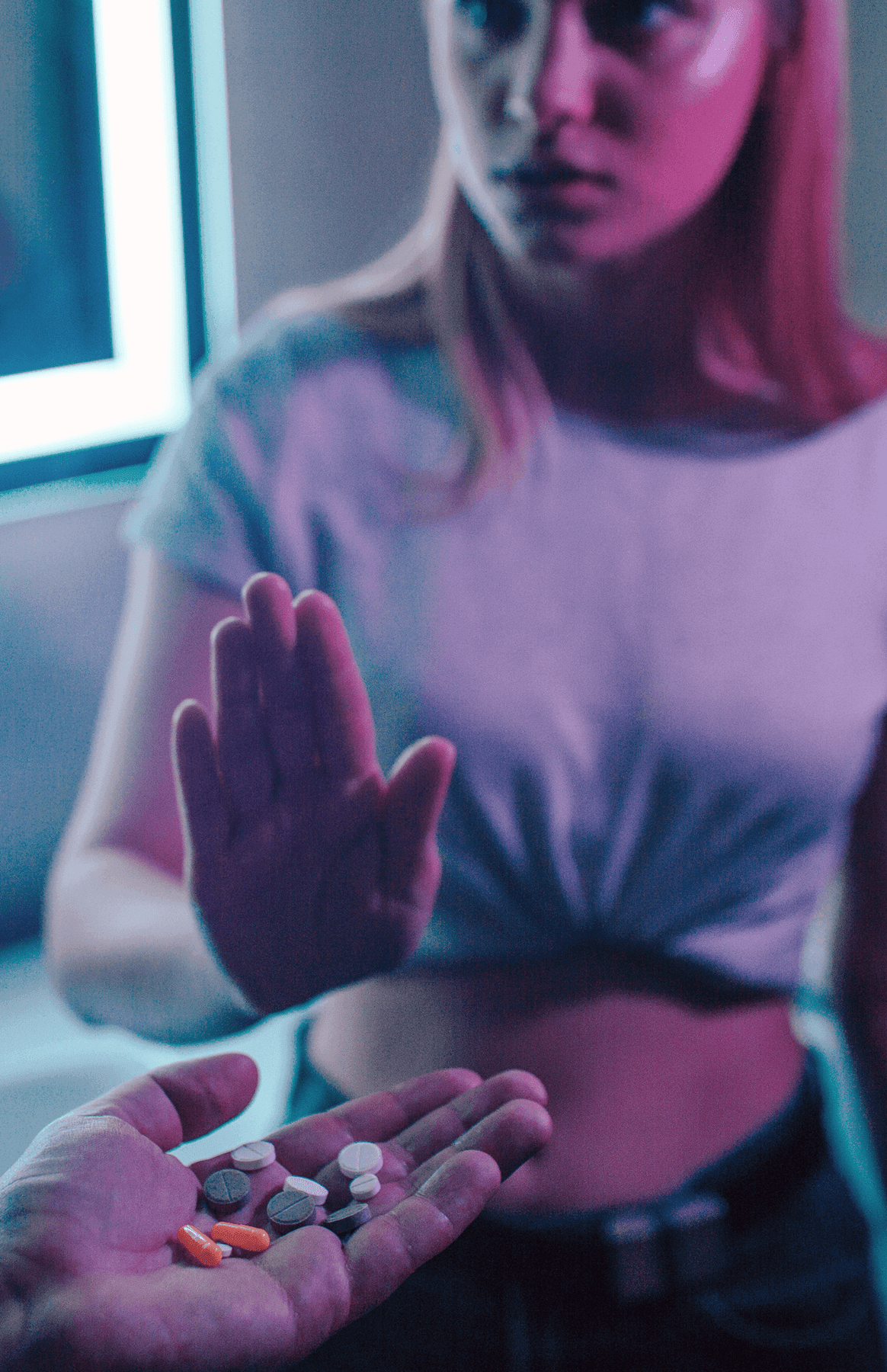 Person refusing pills in outstretched hand.
