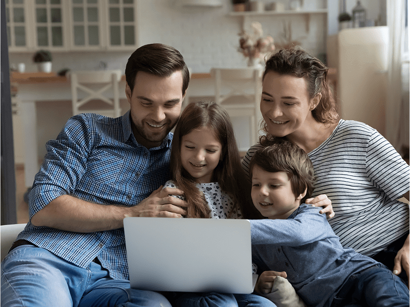 Family enjoying time together on laptop.