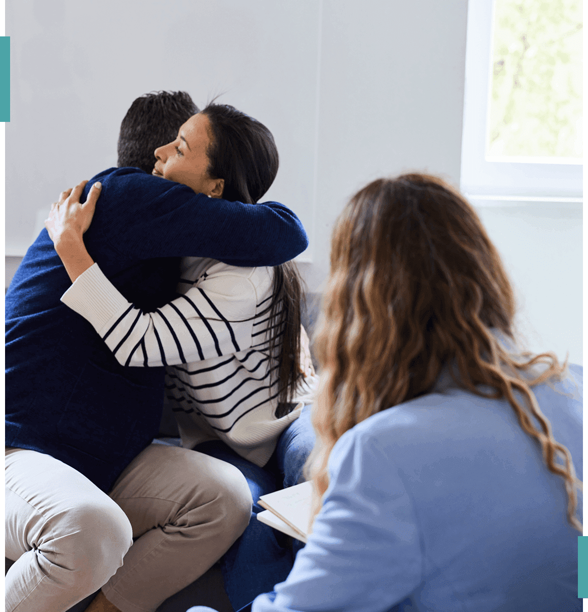 People hugging during a therapy session.