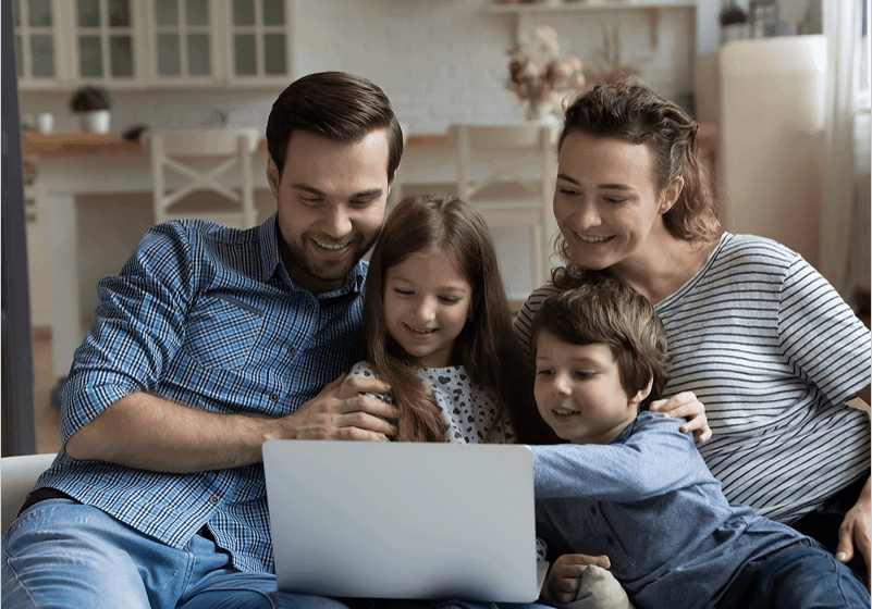 Family enjoying time together on laptop.
